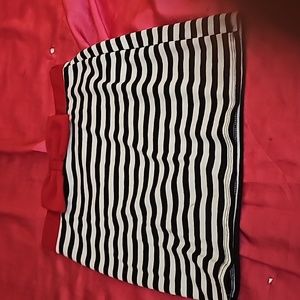 Short skirt with black & white stripes and a red bow around the top.